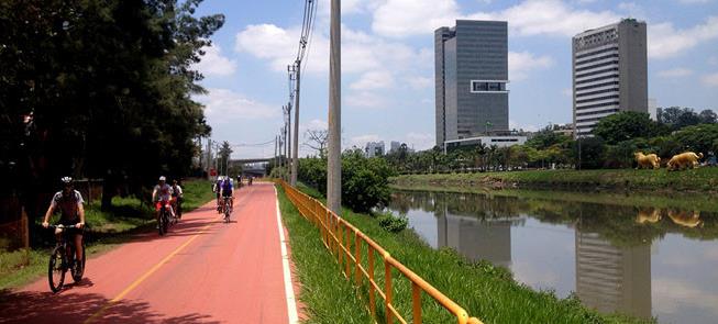 Ciclistas pedalam na ciclovia do rio Pinheiros