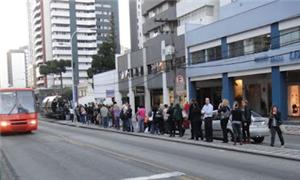 Pessoas esperam o ônibus em Curitiba